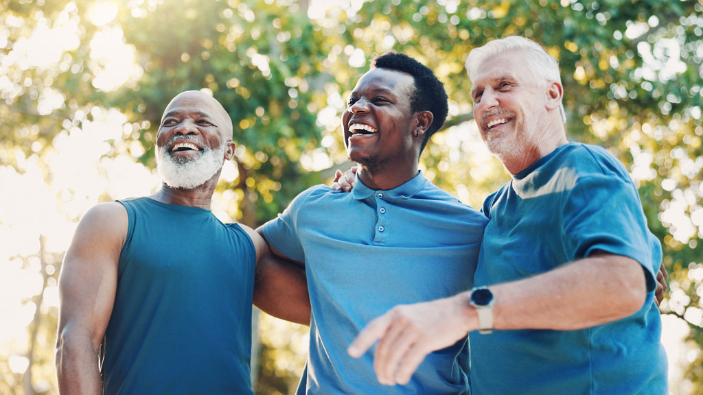 men stood outdoors with their arms around each other wearing blue